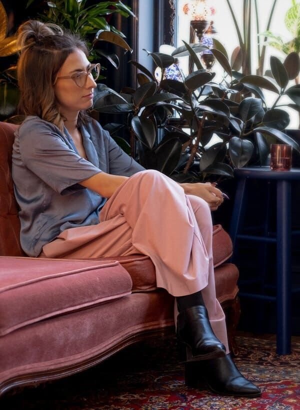 Person seated in a calm counselling space, representing privacy, reflection, and therapy support for first responders